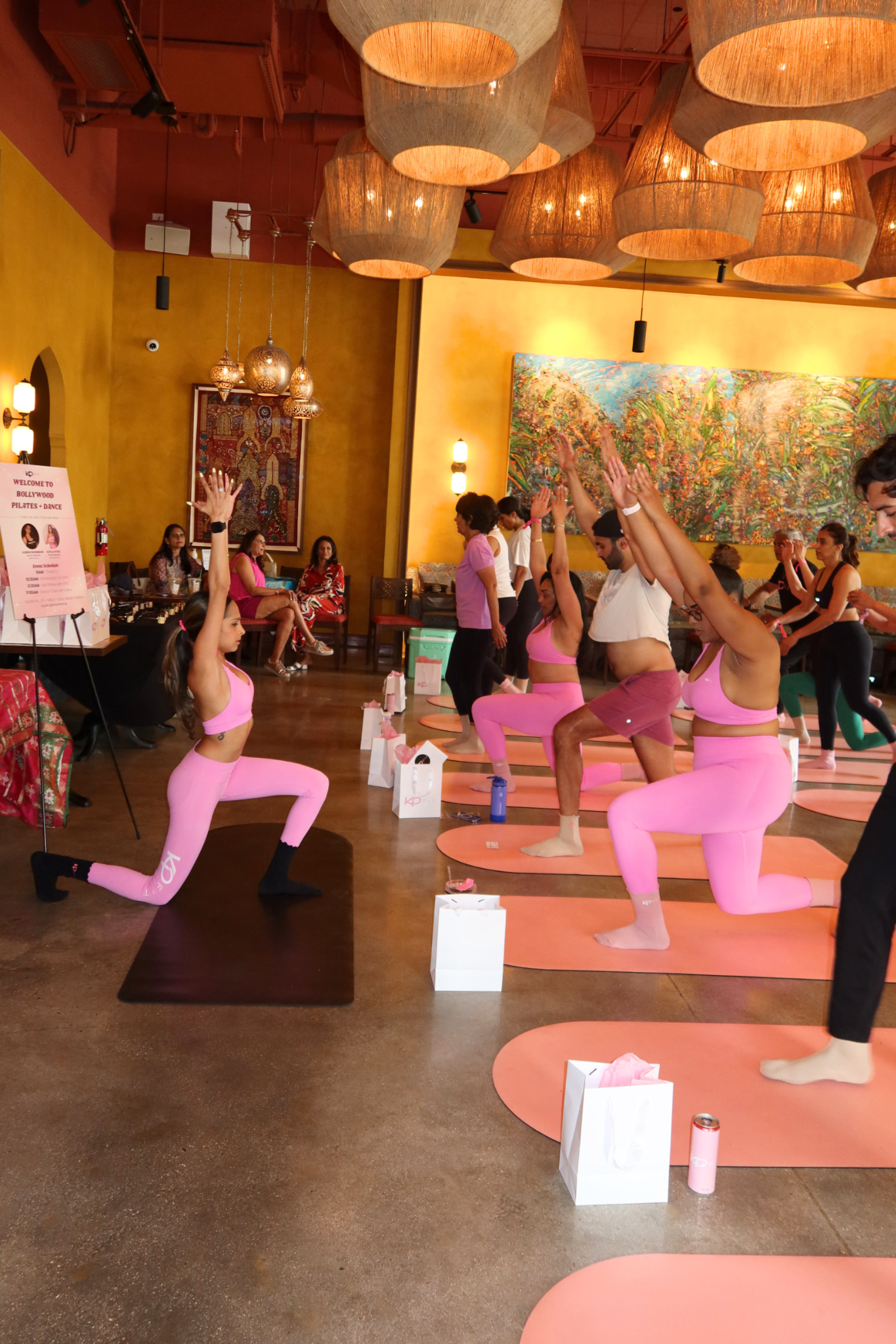 Guests moving through a lunge sequence at Bollywood Pilates