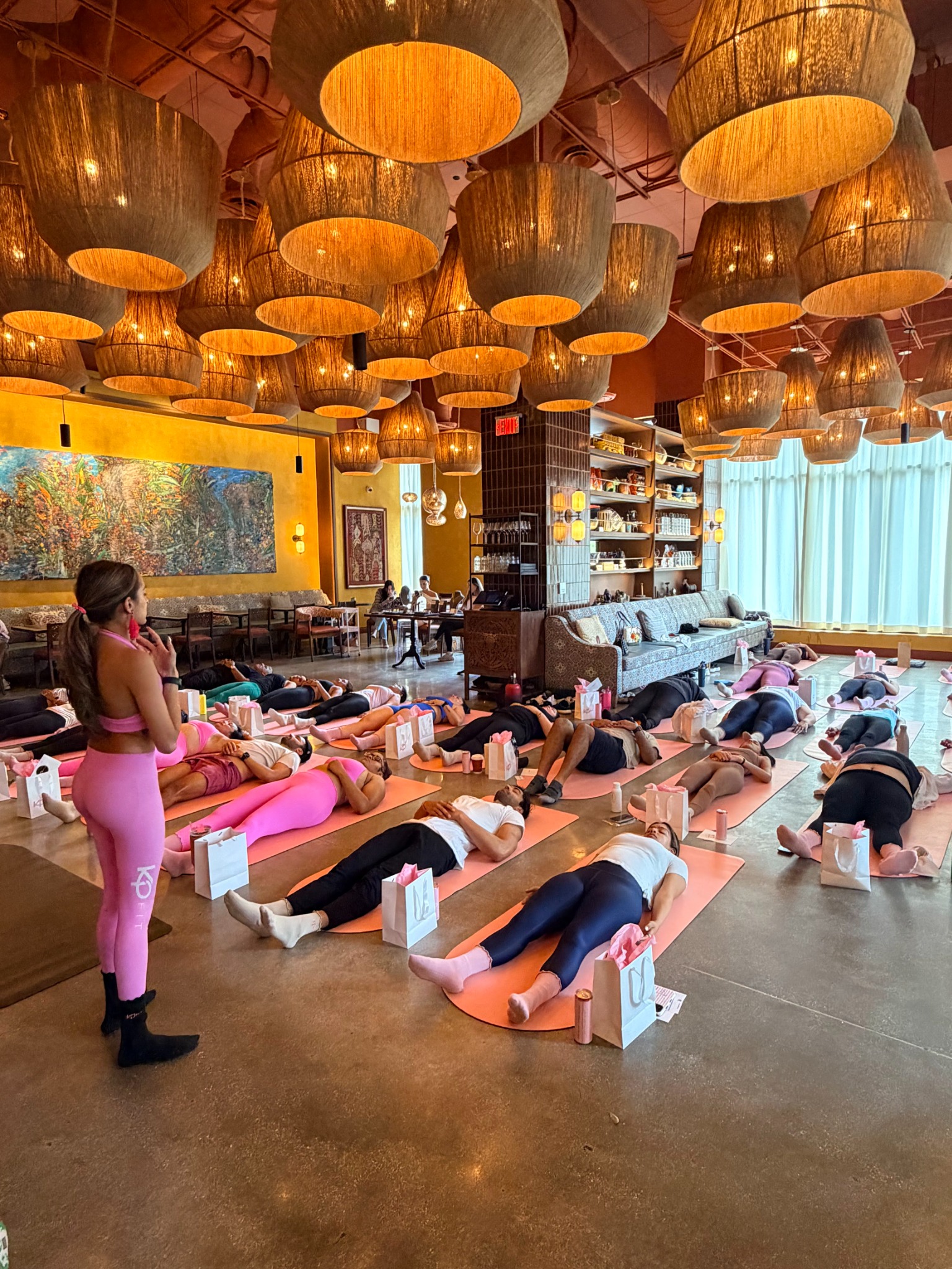 Kayla guiding relaxation at a private Pilates event